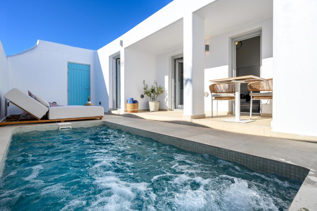 a swimming pool in the backyard of a house at Hypnōs boutique villa with amazing heated pool with jacuzzi in Fira