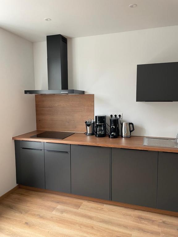 a kitchen with a counter with pots and pans at Colocation à côté d’Artem in Vandoeuvre-lès-Nancy