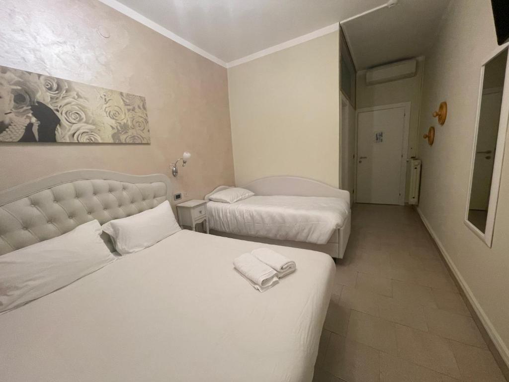 Postel nebo postele na pokoji v ubytování Hotel Central Giacomini