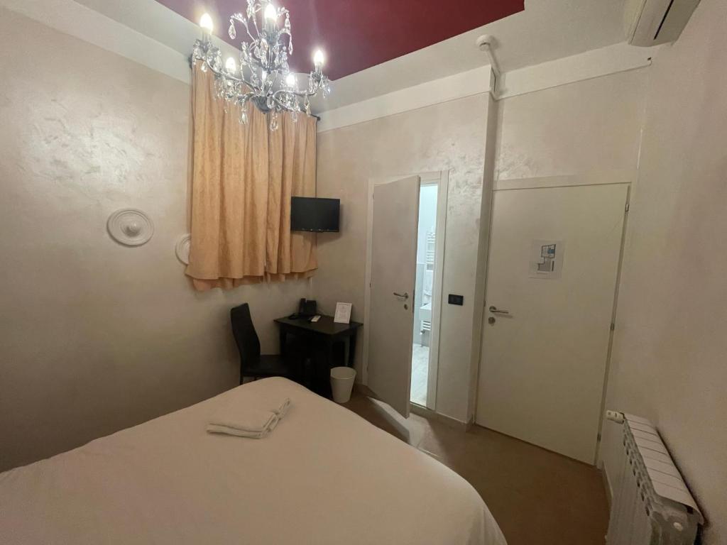Postel nebo postele na pokoji v ubytování Hotel Central Giacomini