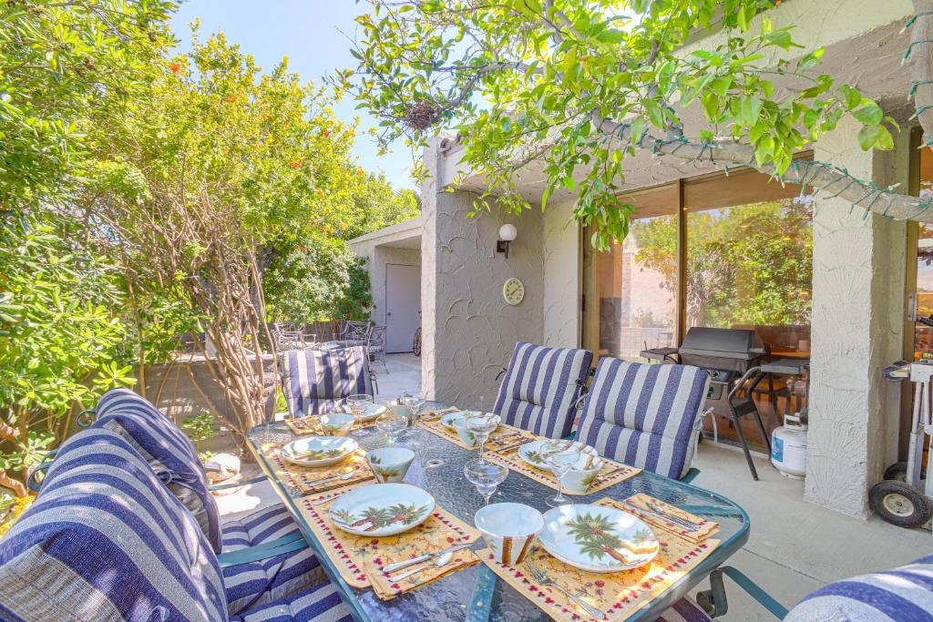 a table with plates of food on a patio at Palm Springs Condo 3 Fenced Patios, Pool Access in Palm Springs