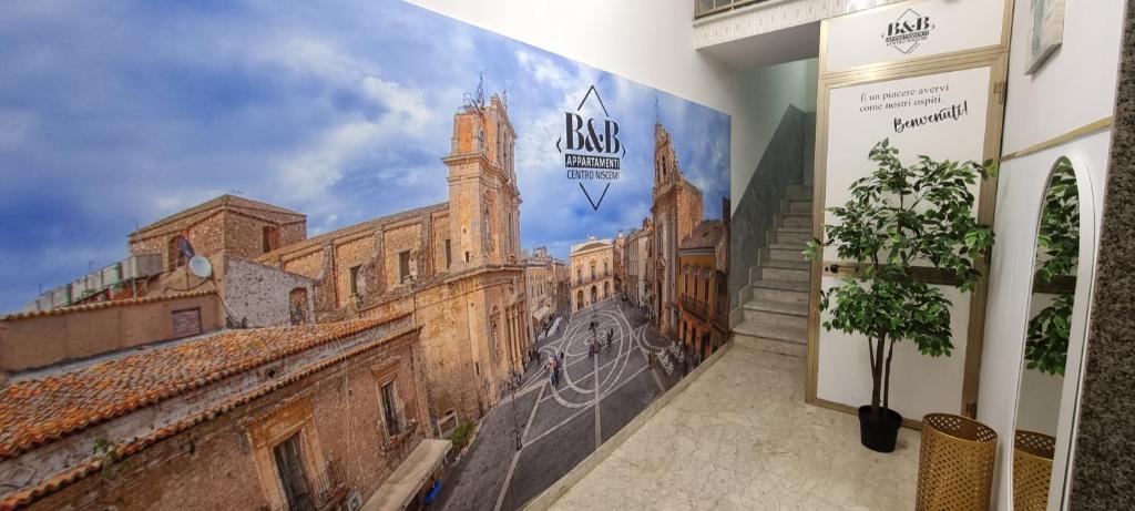 a wall mural of a building with a picture of a city at Appartamento Centro Niscemi in Niscemi