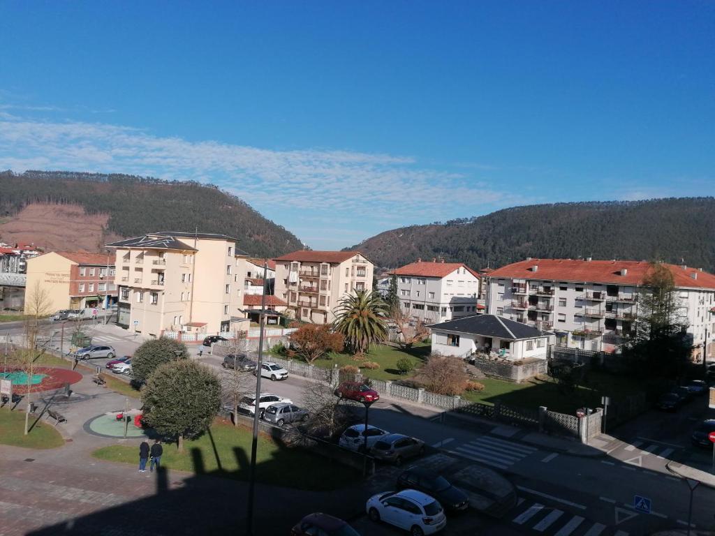 a view of a city with buildings and a parking lot at Dúplex Unquera. Piscina, garaje. in Unquera