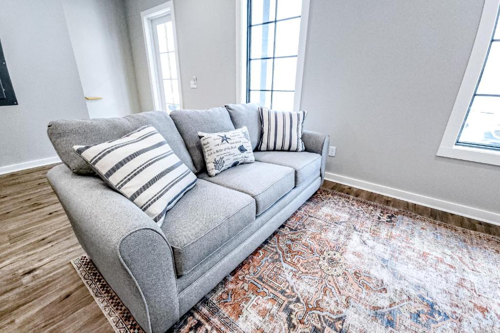 a gray couch in a living room with a rug at Vieux Carre in Port Saint Joe
