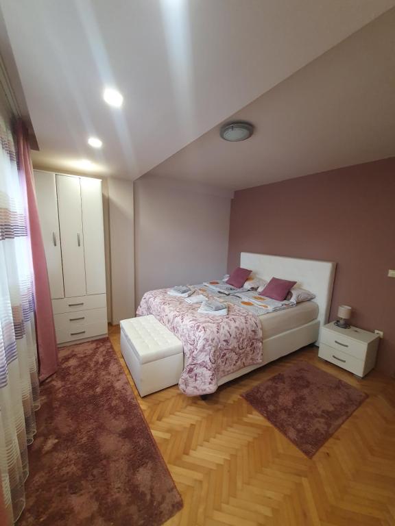 a small bedroom with a bed and a rug at Apartman Lux K in Bijeljina