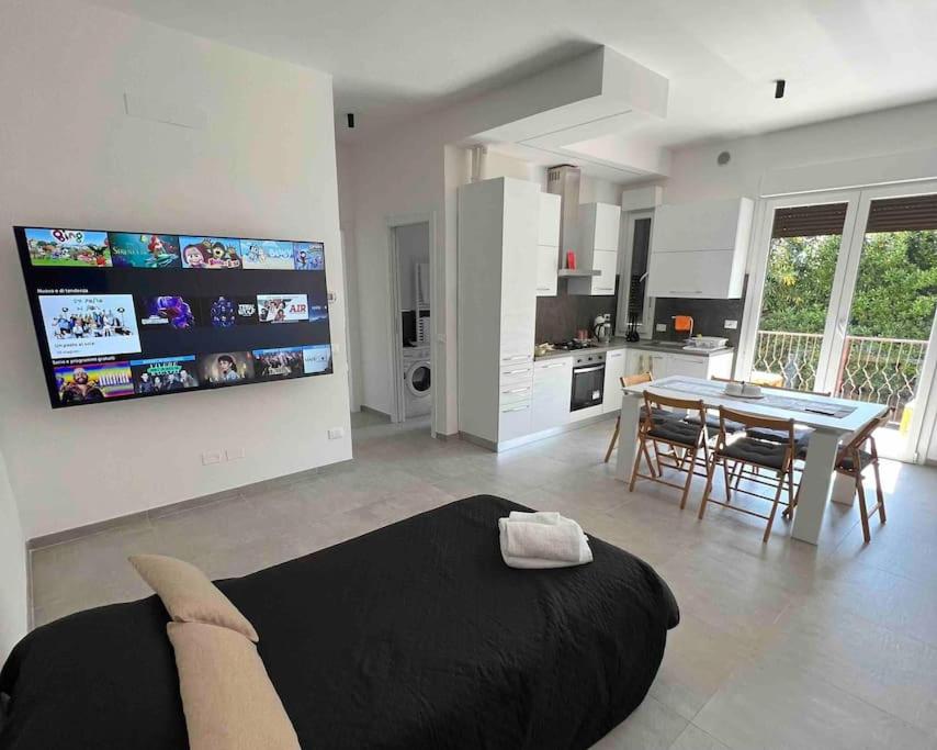a living room with a bed and a dining room at Appartamento al mare - Punta Marina in Punta Marina