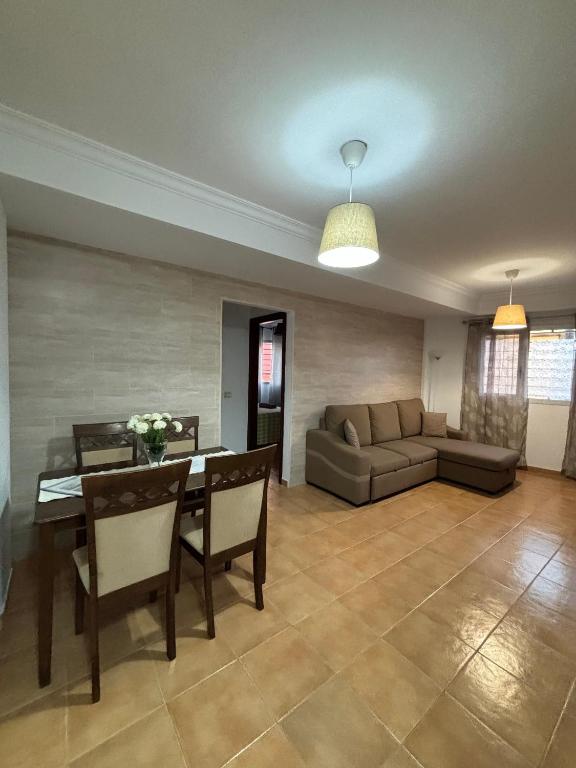 A seating area at APARTAMENT SARDINA NEAR THE BEACH WITH POOL AND WIFI e
