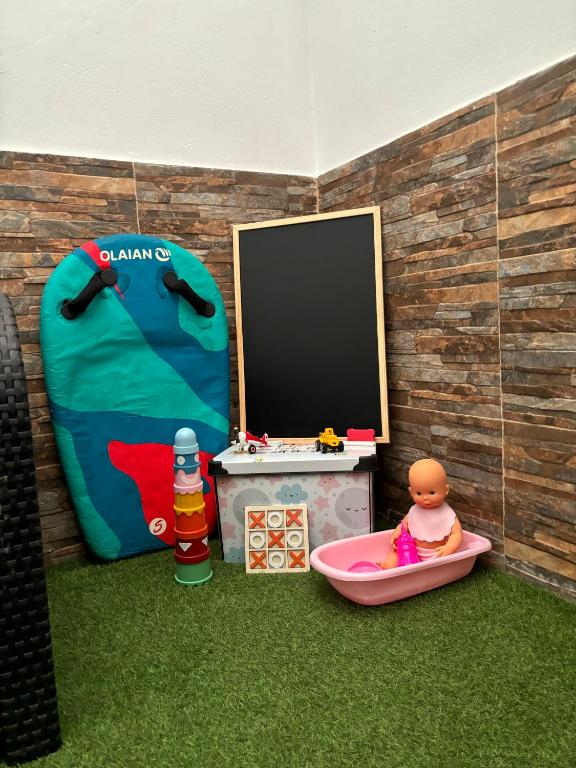 A television and/or entertainment centre at APARTAMENT SARDINA NEAR THE BEACH WITH POOL AND WIFI e