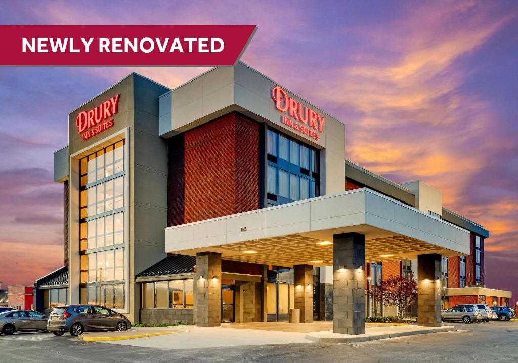 a building with cars parked in a parking lot at Drury Inn & Suites Marion in Marion