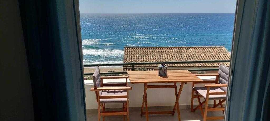 a table and chairs with a view of the ocean at Glyfada New Era Home 120 Menigos Resort Apartments in Glyfada