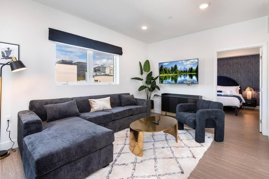 a living room with a couch and a table at Timeless Glamour: Luxury Condo in K-Town in Los Angeles