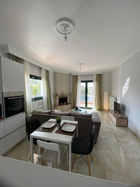 a living room with a couch and a table at Gianna's house in Nikiti