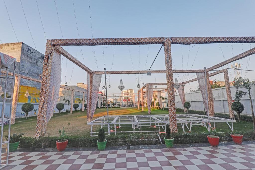 einen Pavillon mit Tischen und Stühlen in einem Park in der Unterkunft Collection O Hotel Starfield in Lucknow