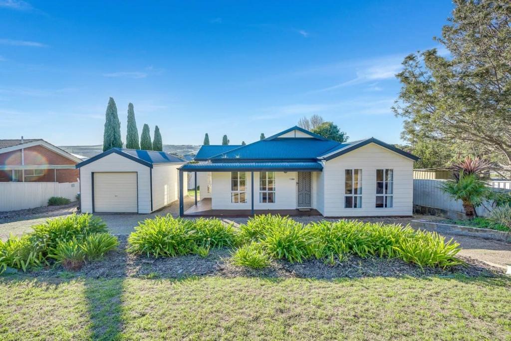 a white house with a blue roof at BONAVIVE Port Elliot - Luxury - Family - Township - No Linen Included in Port Elliot