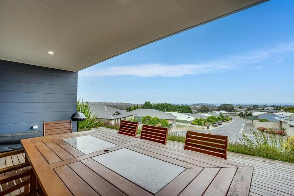 a dining room with a wooden table and chairs at Serendipity - 27 Shields Crs Encounter Bay - No Linen Included in Encounter Bay