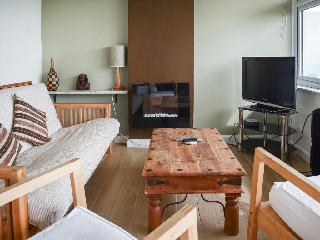 uma sala de estar com um sofá e uma mesa de centro em 21 Hillside em Mundesley