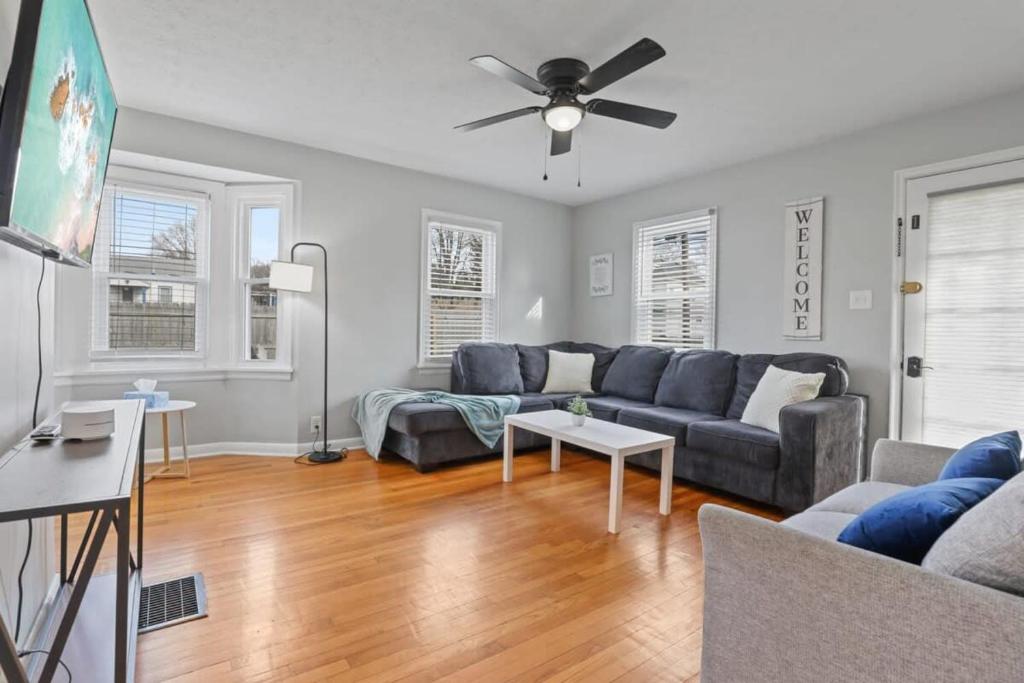a living room with a couch and a ceiling fan at Housepitality - Newark Friends and Family House in Newark
