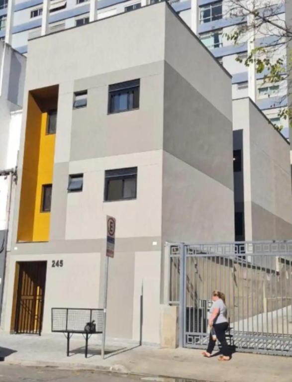 a woman is standing in front of a building at Fabio Av Paulista in São Paulo