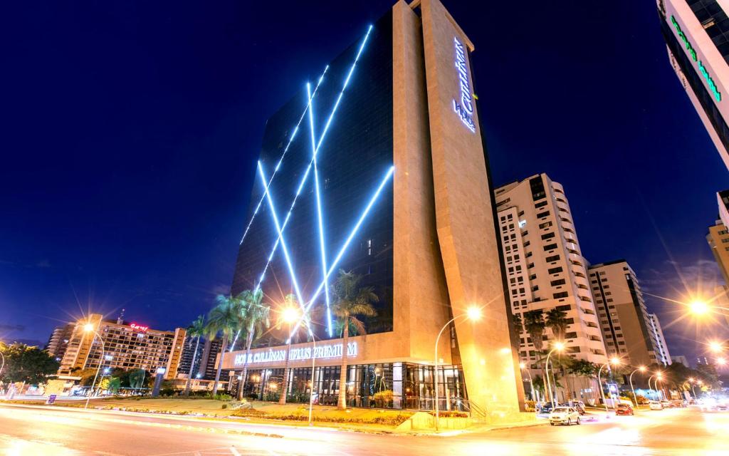 a tall building with lights on it in a city at Brasil flats Cullinan particular in Brasilia