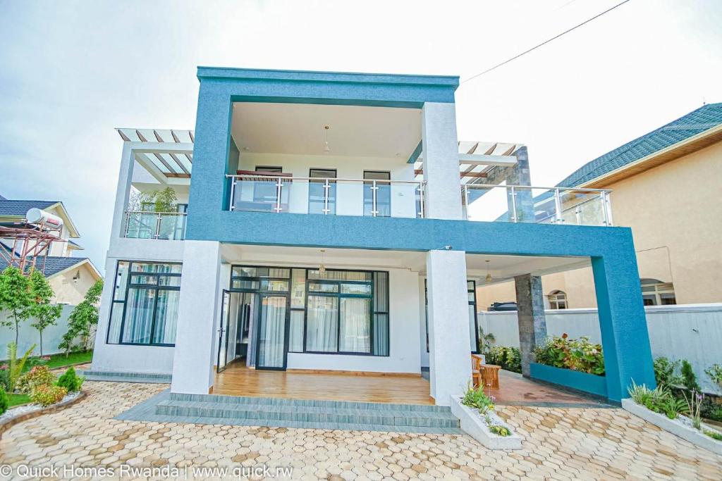 an image of a house with a blue at Travelcation Stay in Kigali