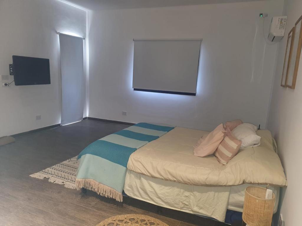 a small bedroom with a bed in a room at Casa en Santa Ana Corrientes capital in Corrientes