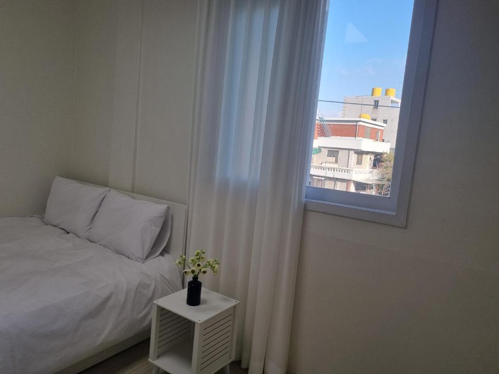 a bedroom with a bed and a window at hongdae housing line 2 st 1 min in Seoul