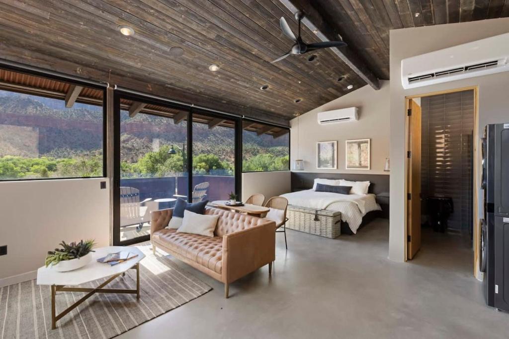 a master bedroom with a bed and a couch at Zion loft with canyon views - unit 1 in Springdale
