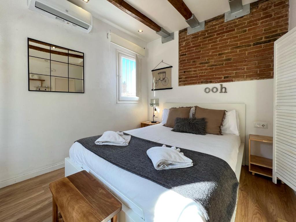 um quarto com uma cama com duas toalhas em Stay U-nique Apartments Torrent em Barcelona