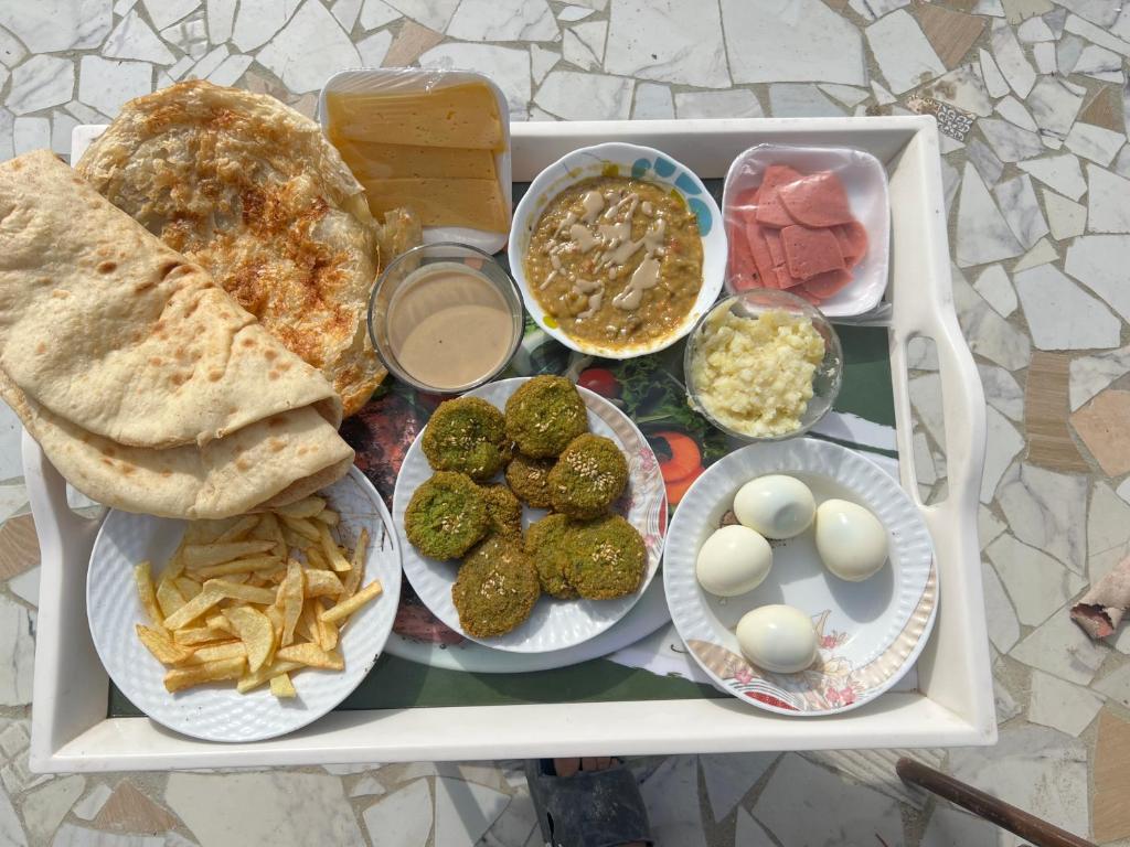a tray of food with different types of food on it at King pyramids view inn in Cairo
