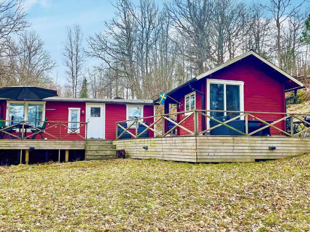 a red house with a large porch and a deck at 8 person holiday home in FAGERHULT-By Traum in Fagerhult