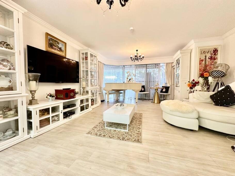 a large living room with a couch and a table at French provincial style, Phoenician Broadbeach in Gold Coast