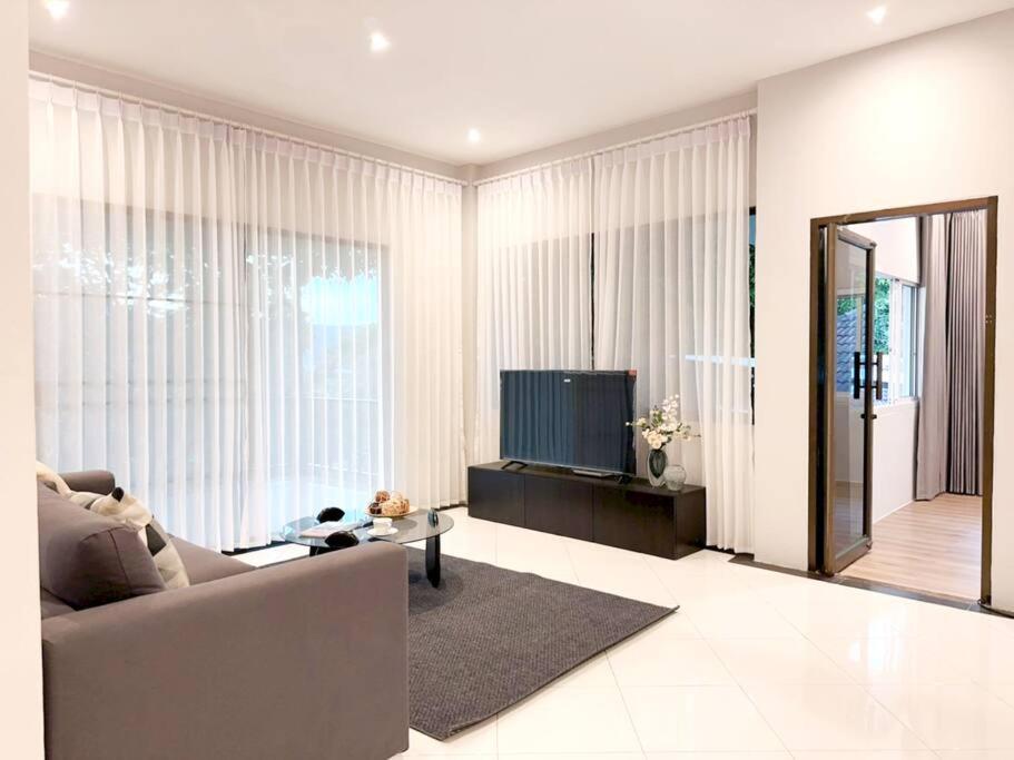 a living room with a couch and a television at Prime Hill , Kathu Phuket / F3 in Phuket Town