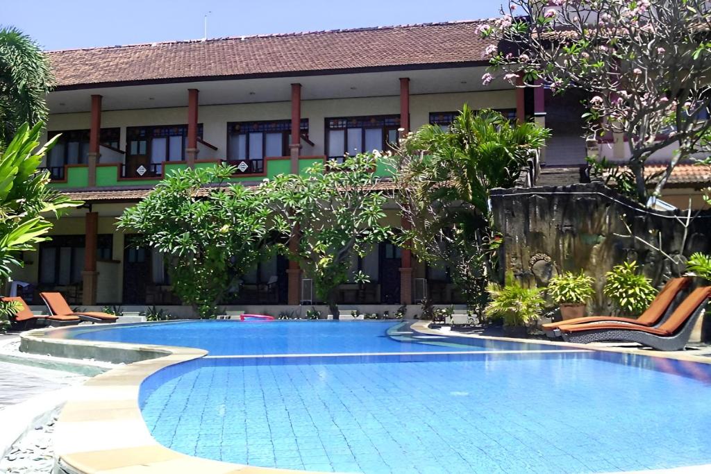 a swimming pool in front of a building at Bali Diva Hotel Kuta in Kuta