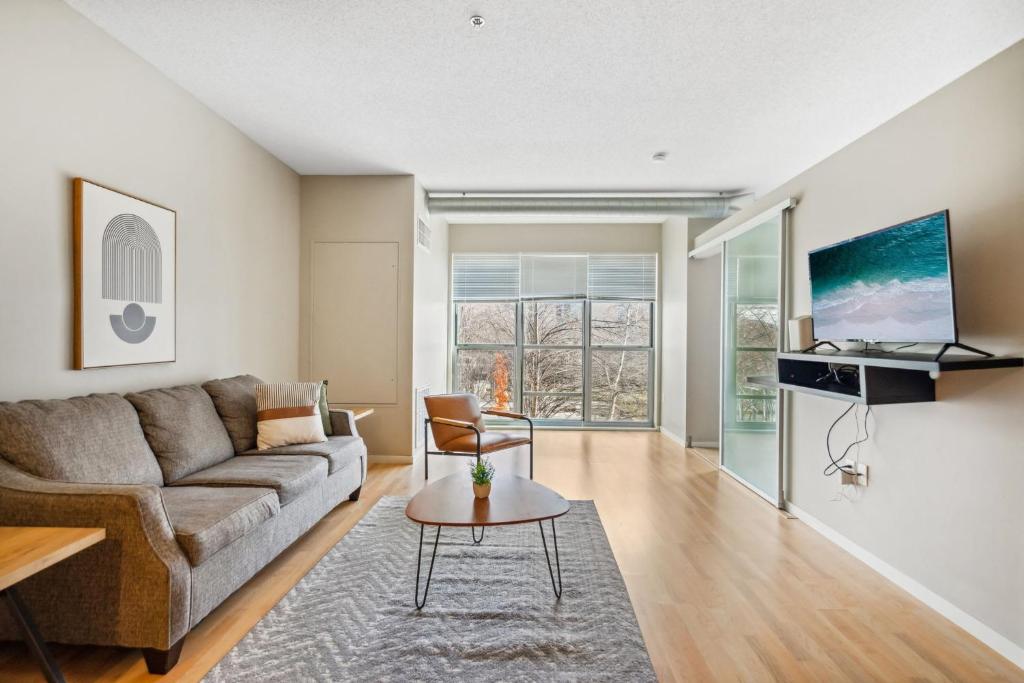 a living room with a couch and a table at CozySuites Mill District pool gym # 08 in Minneapolis