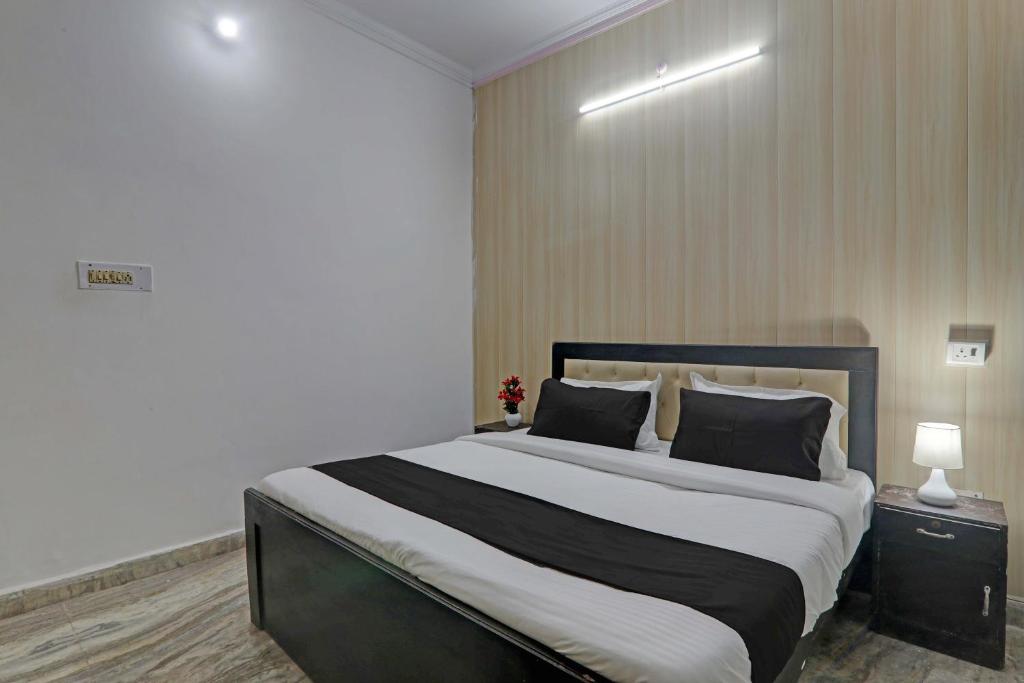 a bedroom with a large bed with two pillows at OYO Flagship Dripp Stay Inn in Lucknow