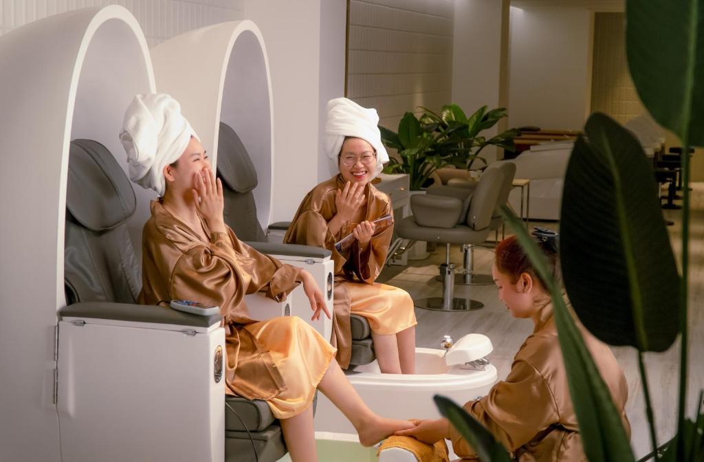 two women sitting in a waiting room with towels on their heads at Awaken Da Nang Hotel in Danang