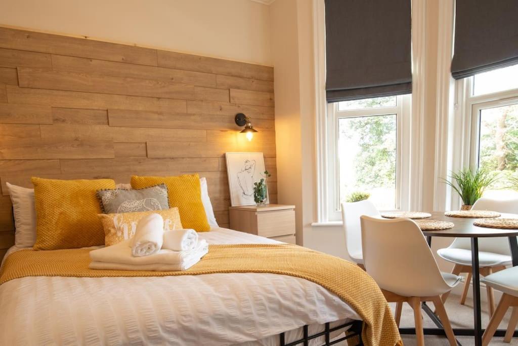 um quarto com uma cama, uma mesa e cadeiras em Family Apartment, Close to Town and Beach em Eastbourne