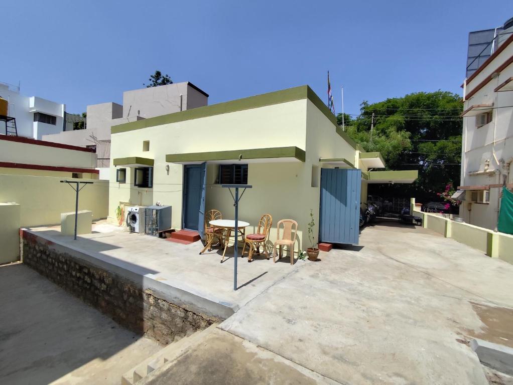 a building with a patio with a table and chairs at Park View in Mysore