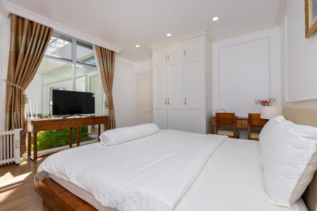 Ein Bett oder Betten in einem Zimmer der Unterkunft Biệt Thự Lan Anh Đà Lạt