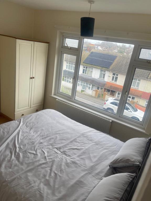 a bedroom with a large bed and a window at ODF foundation apartments in Strood