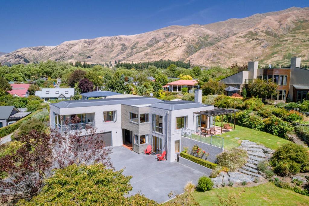 an aerial view of a house with mountains in the background at Sargood Splendour - Wanaka Holiday Home in Wanaka