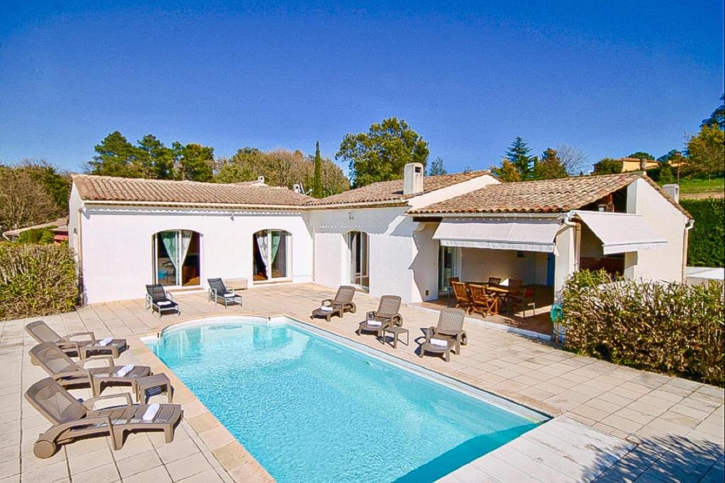 une piscine avec des chaises et une maison dans l'établissement Country villa - Sleeps 8 - Mimosa view, à Tanneron