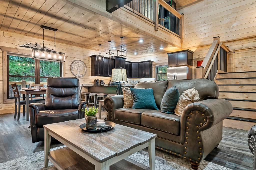 a living room with a couch and a table at New Luxury Vacation Home Cabin in Smoky Gatlinburg - Theater Room in Gatlinburg