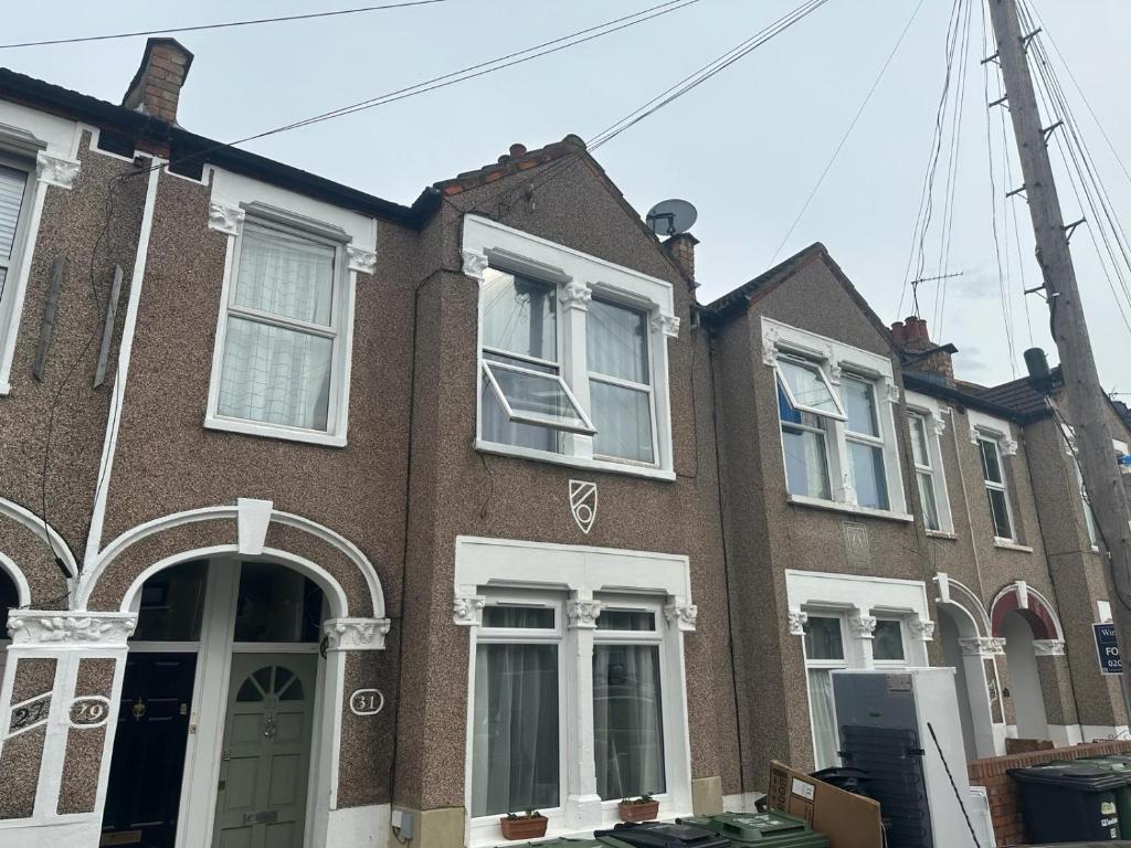 a brown brick house with white windows at 3 Bedroom Apartment, Flat in London in Forest Hill