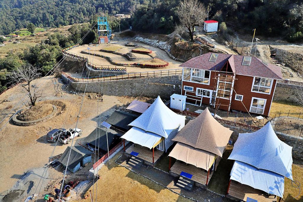 an aerial view of a house with tents and a building at MUSSOORIE ADVENTURE RESORT in Mussoorie