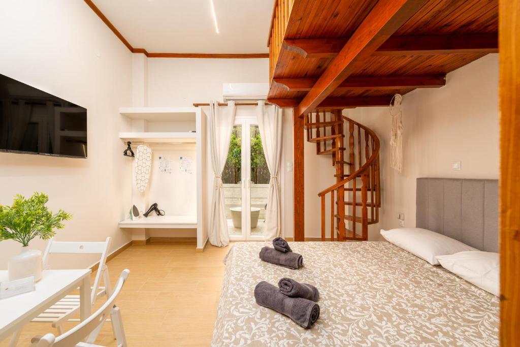 una camera con un letto e due pantofole sopra di Dionysia Sea Side By Greece Apartment a Selianitika