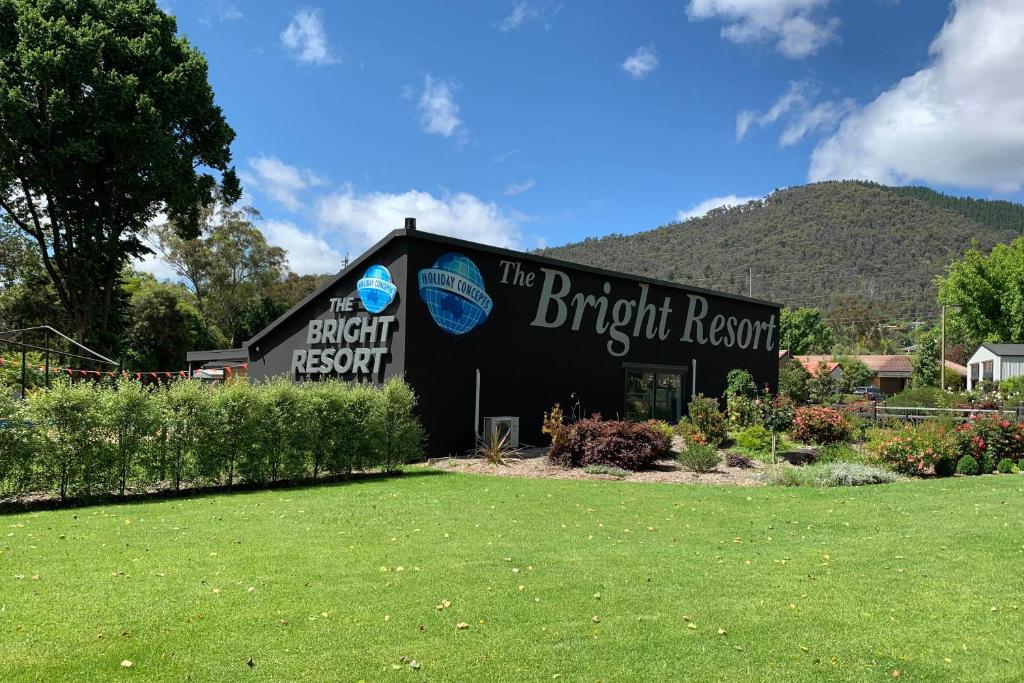a black building with a sign on the front of it at The Bright Resort in Bright