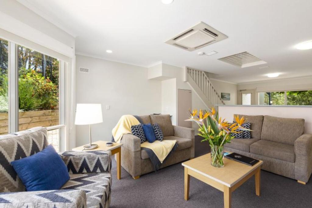 a living room with two couches and a table at Island Breeze Resort in Cowes