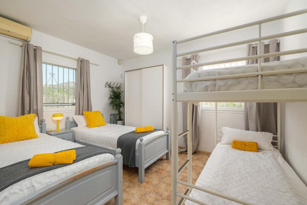 トロクスにあるBuena Vistaのベッドルーム1室(黄色をアクセントにした二段ベッド2組付)