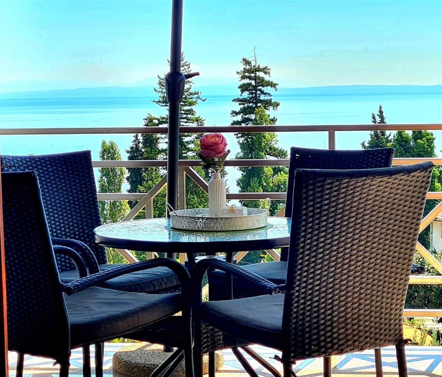 a table and chairs on a balcony with the ocean at Apartment Lapov in Ičići